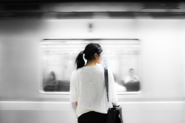 Photo of a woman standing on a subway platform