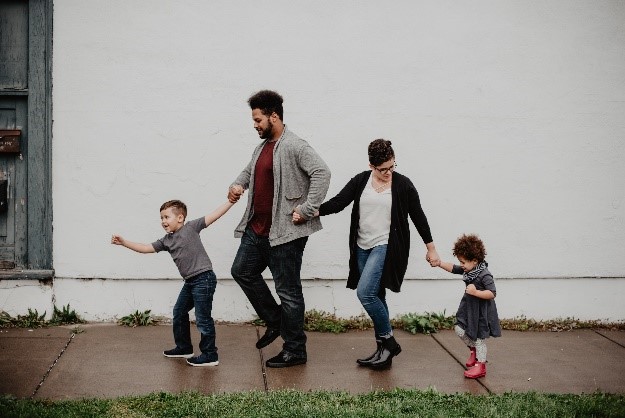 Family holding hands and taking a stroll