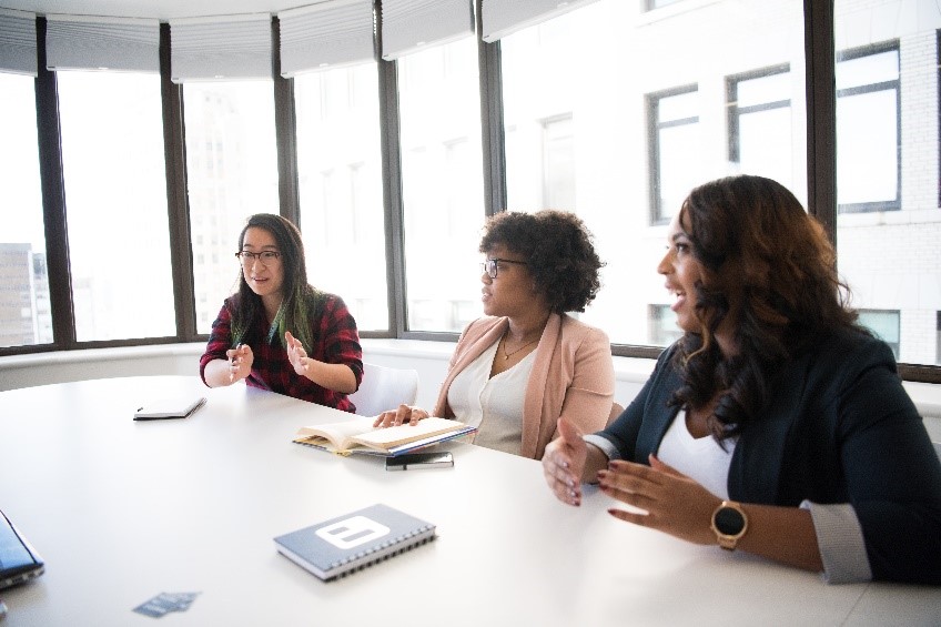 Three female workers meeting in a conference room