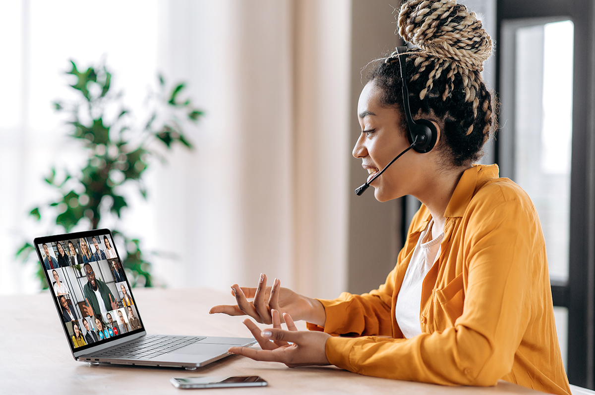 Woman wearing a headset and talking in a virtual meeting