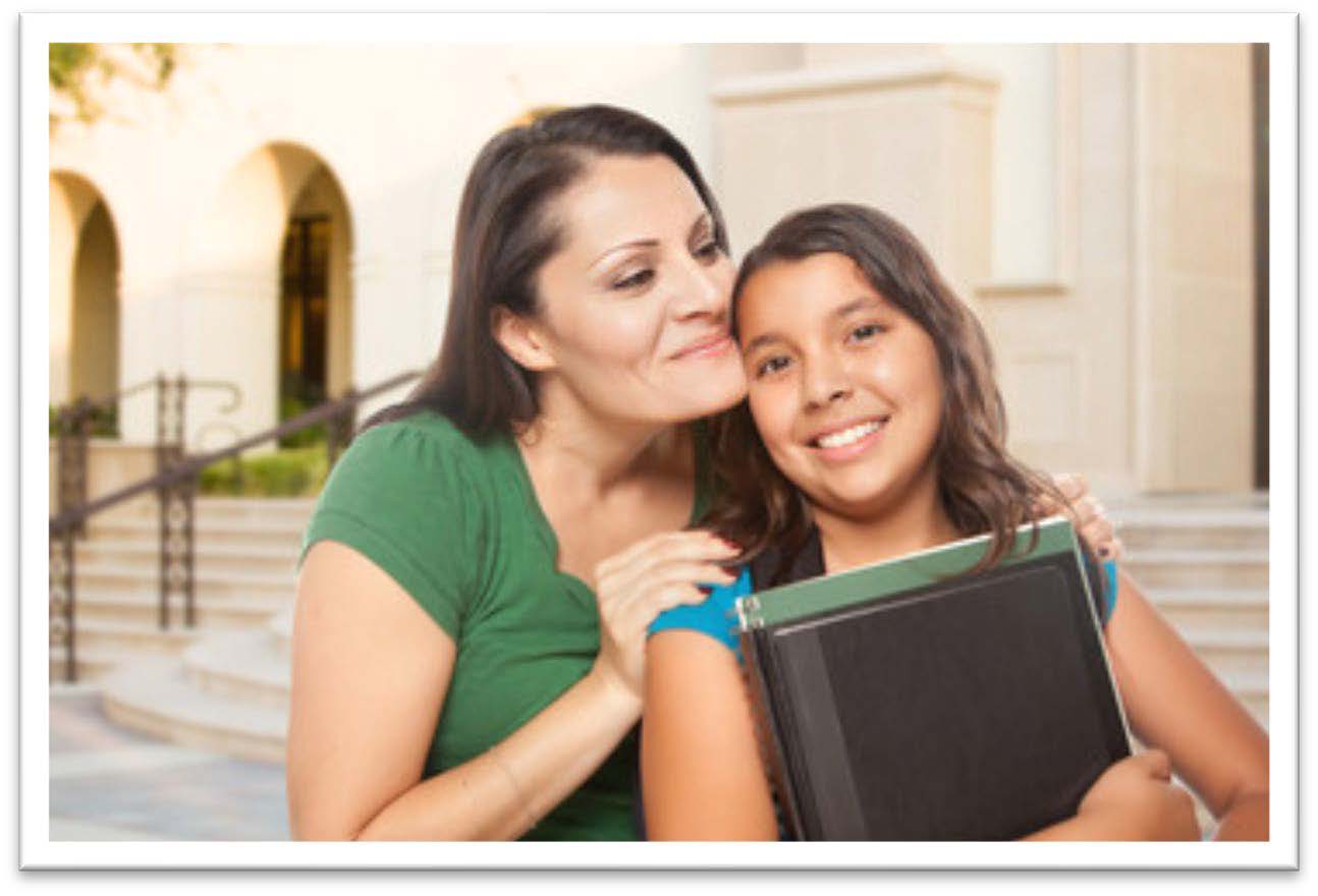 Parent hugging a child on the steps of building