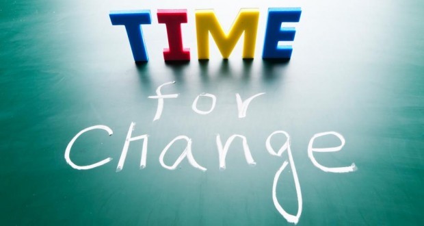 Letter blocks that spell Time with chalk writing that states for change underneath