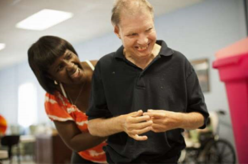 Caregiver assisting a man.