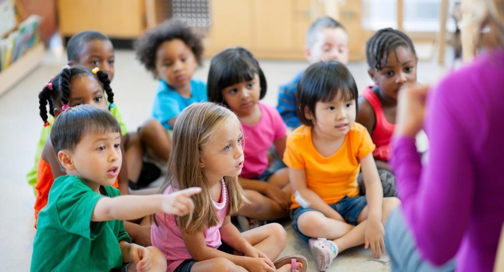 Group of Children sitting around Teacher