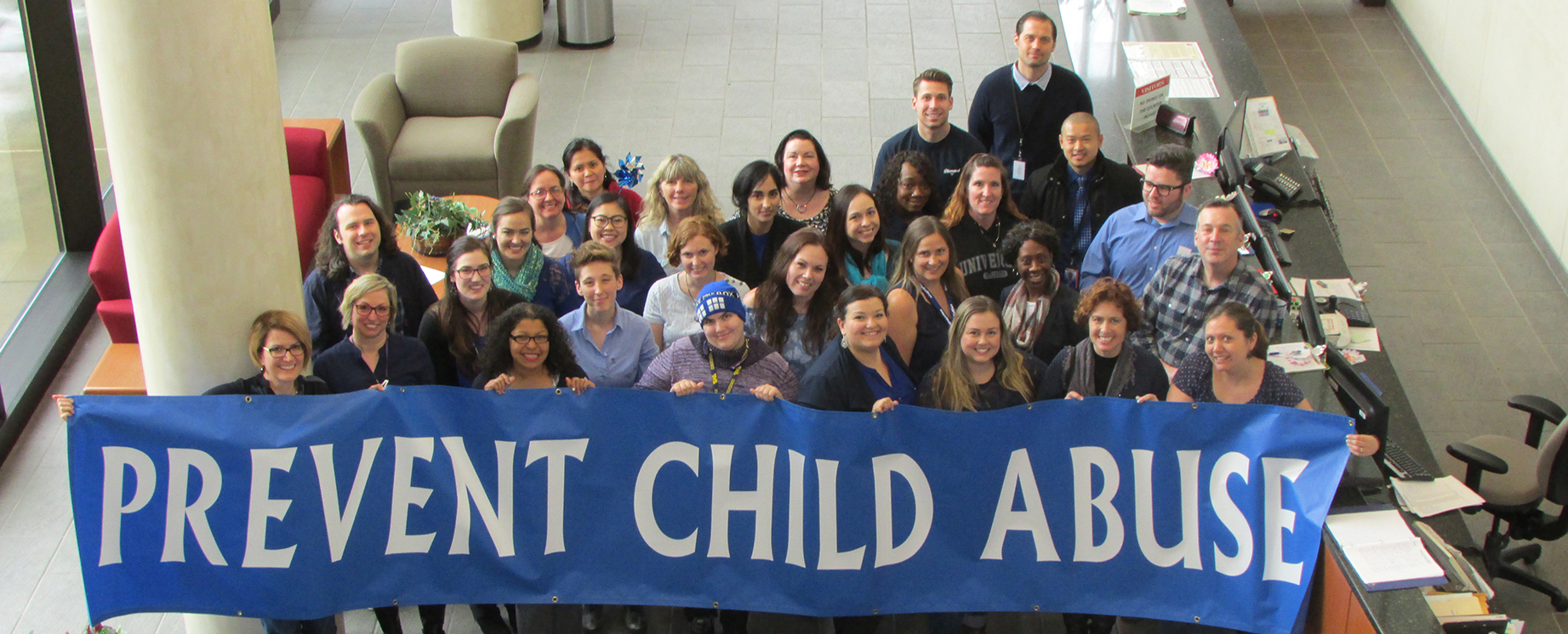 CDSS Employees holding up a Child Abuse Prevention Sign