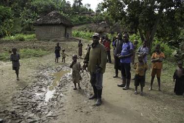 Photo of Men, women, children in village