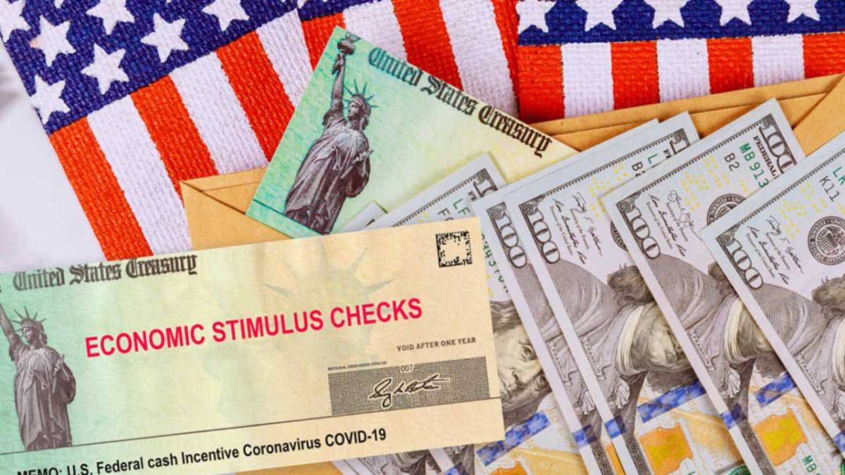 Stimulus checks and cash resting on the American flag