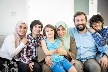 A family smiling together at home — Refugee Programs Bureau